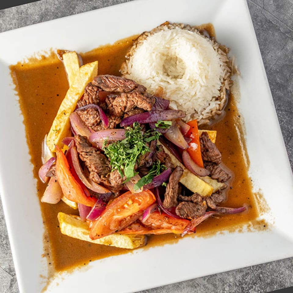 Chios Peruvian Grill's Lomo Saltado, a Peruvian stir-fry with beef, vegetables, fries, and rice.